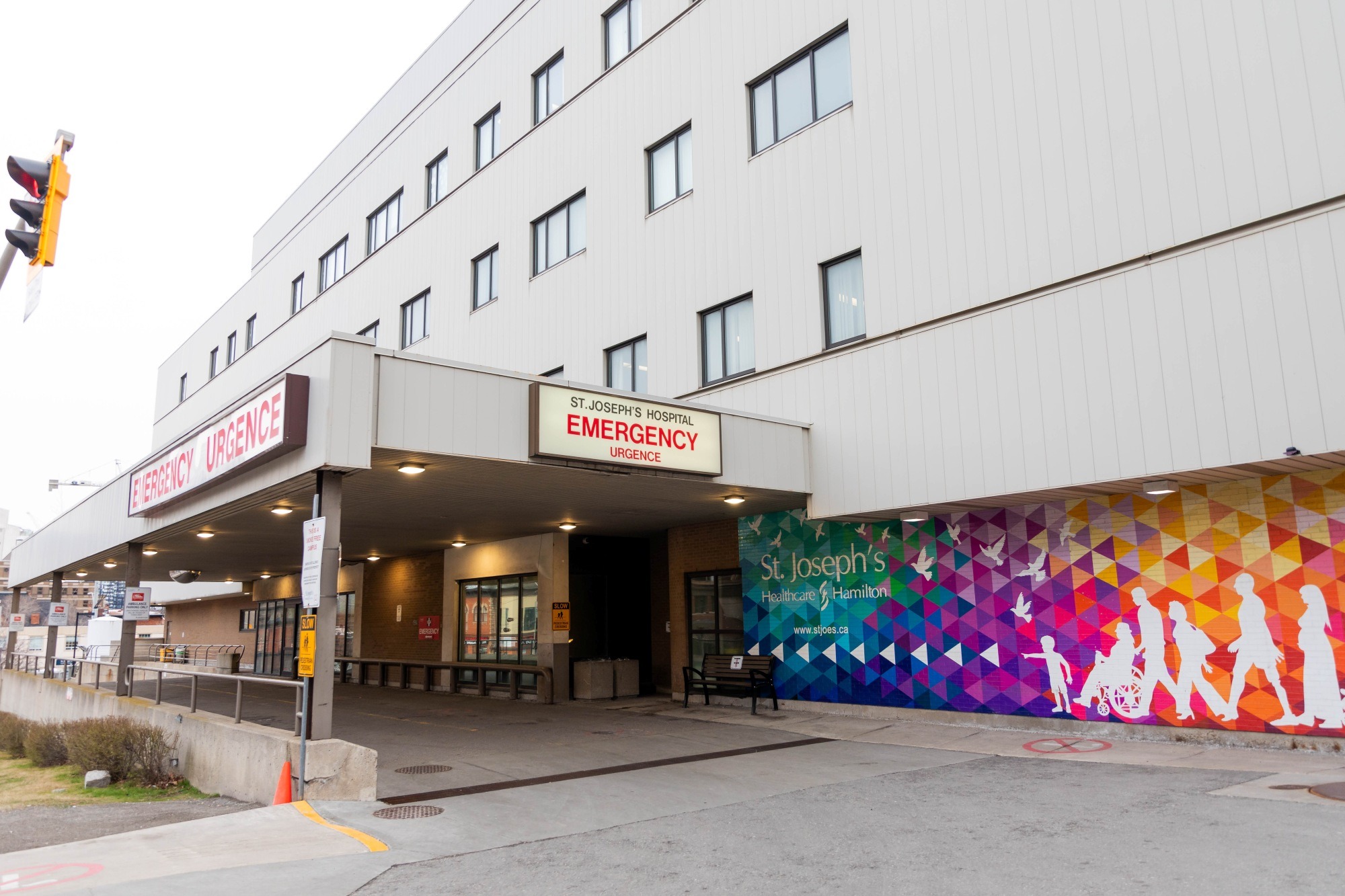 The St. Joseph's Hospital emergency entrance outside features a geometric rainbow mural.